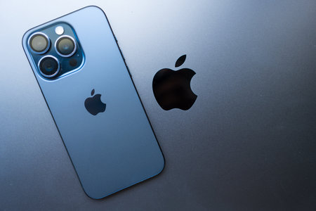 Bangkok, Thailand - December 27, 2023 : Modern smartphone Apple New iPhone 15 pro max blue titanium placed on a Apple MacBook Pro space black laptop.のeditorial素材