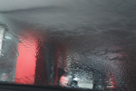 Focus only on drops of water, jet spraying to car out of focus. Car wash expertの写真素材