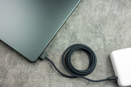 Bangkok, Thailand - December 28, 2023 : Close up a black braided USB-C cable charge and connect to Apple Macbook Pro with M3 Maxのeditorial素材