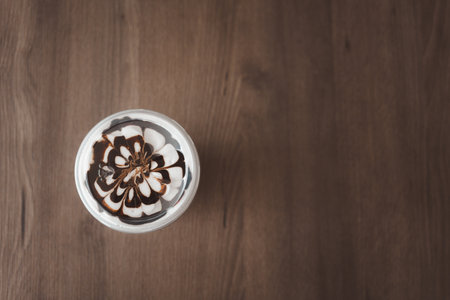 Latte art on milk foam with mocha ice coffee. Top view with copy space.の写真素材