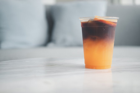 Ice americano orange coffee in cup. Close upの写真素材
