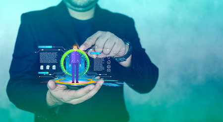 Businessman holding a holographic and selects candidates resumes. The concept of finding employees in a company, career growth, identifying talented people, interface and global network media conceptの写真素材