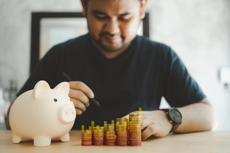Man calculating the share of income, income, expenses, money for planning family savings financial...