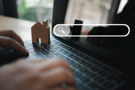 Search Engine Optimization, searching estate information online, man use computer to search data on internet, finding on website online. Concept of mortgage, rental housingの写真素材