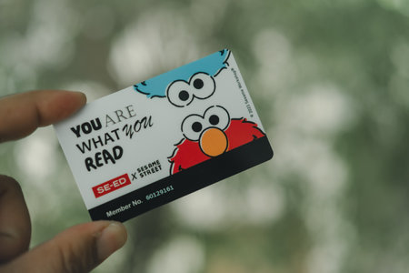 Bangkok, Thailand - January 7, 2024 : Man hand holding member card SE-ED Book Center book retail store. The biggest international bookstore in Thailand.のeditorial素材