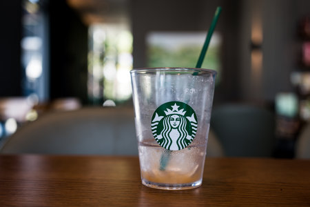 Bangkok, Thailand - January 7, 2024 : Close up a crystal glass with Starbucks logo after drink finish at Starbucks coffeeのeditorial素材