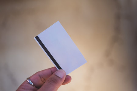 Man holding a movie tickets from seller at box office. Blank ticket for mockup designの写真素材
