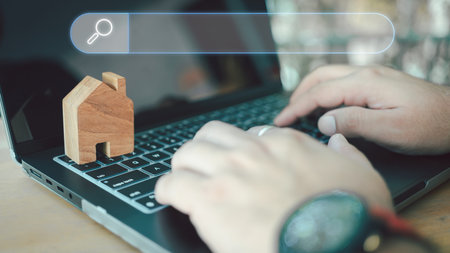 Men use computer laptop to find what they are interested about real estate. Searching information home data on internet networking. Home realtor business conceptの写真素材