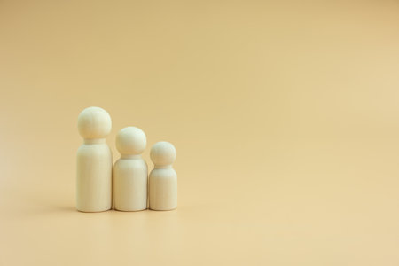 Wooden peg dolls men women and children with copy space for text. Family day warmth happiness life insurance concept.の写真素材