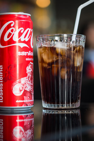 Bangkok, Thailand - January 9, 2024 : A can Coca-Cola and a clear glass with ice. Coca-Cola is one of the world favorite carbonated beverages.のeditorial素材