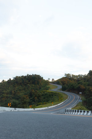 Beautiful curved road known as number 3 road on the high mountain along the way to Bo Kluea district in Nan province, Thailand, An iconic tourist attractionの写真素材