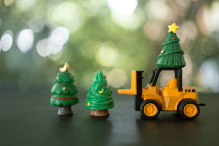 A toy forklift driver transport christmas trees at Christmas day. Theme Christmas day background.