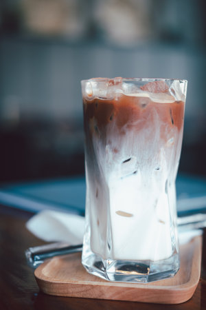 Refreshing summer drink concept. A glass of ice mocha show with beautiful texture and layers fresh milk and coffee.の写真素材