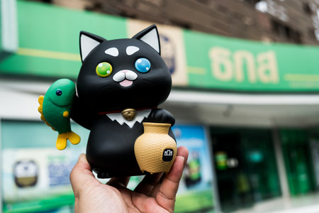 Bangkok, Thailand - Jan 13, 24: Khun ME Chok piggy bank, from a BAAC savings bank, a black cat, to foster savings habits in children and youth through depositing money in the National Children's Dayのeditorial素材