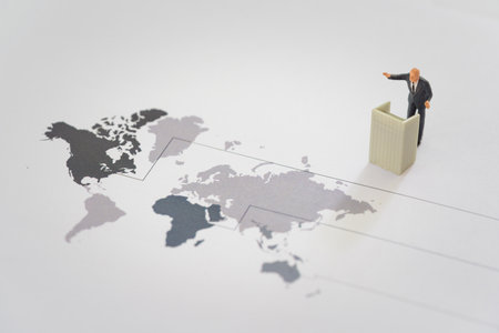 Miniature of businessman stands on podium ladder with world map. Financial and business competition conceptの写真素材