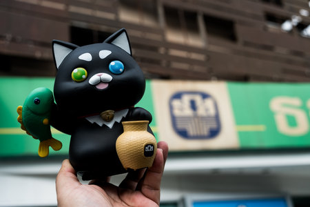 Bangkok, Thailand - Jan 17, 24: Khun ME Chok piggy bank, from a BAAC savings bank, a black cat, to foster savings habits in children and youth through depositing money in the National Children's Dayのeditorial素材