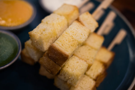 Slightly golden toast cut square, just the right size put in a stick ready to eat