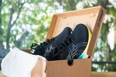 Bangkok, Thailand - January 24, 2024 : Open box of new shoes with ASICS Running Shoes Gel Nimbus 25 WIDE.のeditorial素材