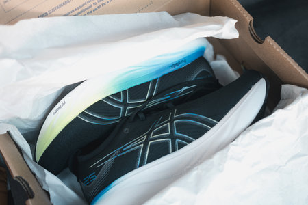 Bangkok, Thailand - January 24, 2024 : Open box of new shoes with ASICS Running Shoes Gel Nimbus 25 WIDE.のeditorial素材