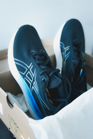 Bangkok, Thailand - January 24, 2024 : ASICS Running Shoes Gel Nimbus 25 WIDE in brown box. Japanese multinational corporation athletic equipment company which produces footwear and sports equipmentのeditorial素材