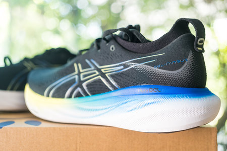 Bangkok, Thailand - January 24, 2024 : Running shoes from the brand Asics placed on box. ASICS is a Japanese athletic equipment company that produces cushioning footwear.のeditorial素材