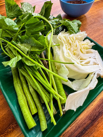 Fresh vegetables for eating with papaya salad on wood tableの写真素材