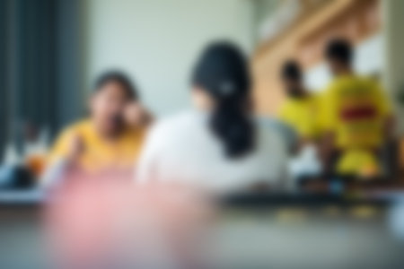 Blurred image of people sitting at the restaurant. People eating togetherの写真素材