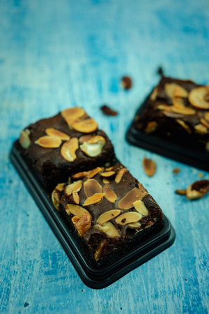 Chocolate brownie cake dessert decorated with nut on boxの写真素材