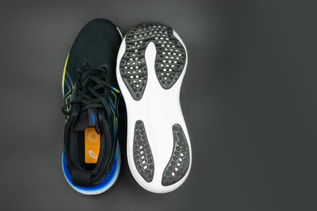 Bangkok, Thailand - February 3, 2024 : New ASICS Running Shoes Gel Nimbus 25 WIDE. Creative shot of Asics sport sneakers for jogging.のeditorial素材