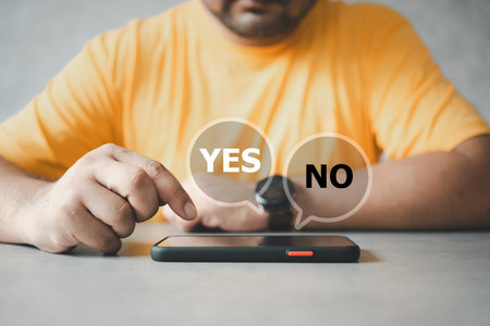Young man is thinking and making choices between right or wrong. Decide to vote concept. Yes or No decisions, choosing between yes no via smartphone, decision yes no. Making a decision life.の写真素材