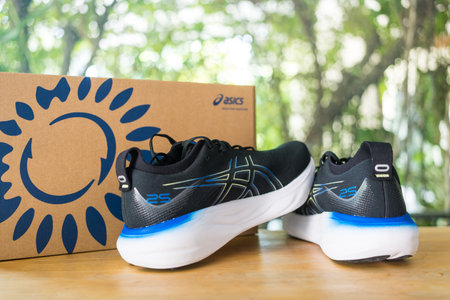 Bangkok, Thailand - February 5, 2024 : New ASICS Running Shoes Gel Nimbus 25 WIDE. Creative shot of Asics sport sneakers for jogging.のeditorial素材