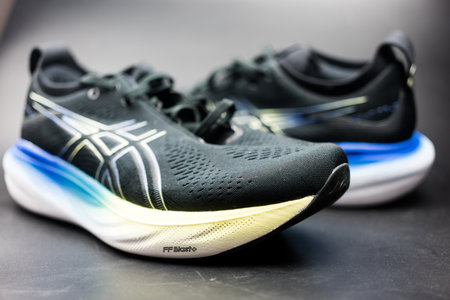 Bangkok, Thailand - February 5, 2024 : New ASICS Running Shoes Gel Nimbus 25 WIDE. Creative shot of Asics sport sneakers for jogging.のeditorial素材