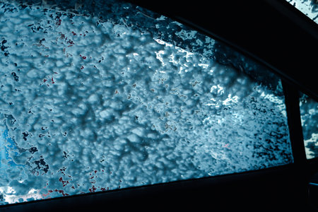 Driver view looking out through the windshield while going through an indoor automatic car wash.の写真素材