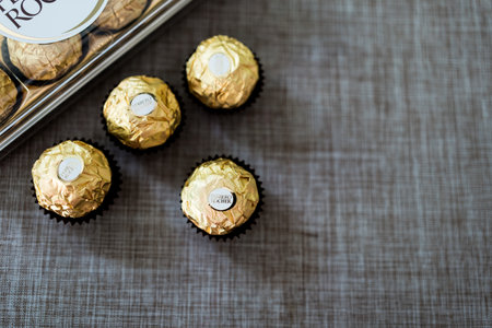 Bangkok, Thailand - February 23, 2024 : Ferrero Rocher, chocolates with crunchy wafer shell and hazelnut filled with chocolate wrapped in golden paperのeditorial素材