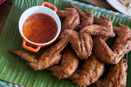 Fried crispy chicken wings with sweet sauceの写真素材