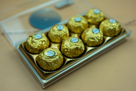 Bangkok, Thailand - February 29, 2024 : Ferrero Rocher candy in plastic container. Candy in branded packaging, a sweet pleasure for children and adults. Luxurious design packagingのeditorial素材