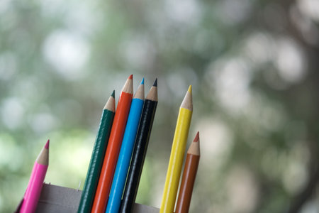 Colorful colored pencils on blurred bokeh nature background. The concept of preschool and school educationの写真素材