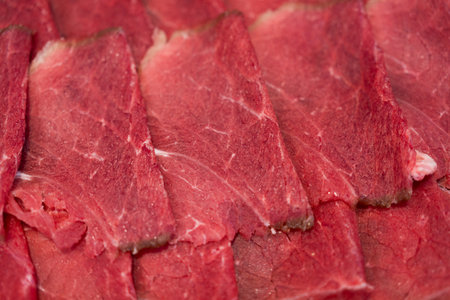 Sliced raw beef meat for hot pot, yakiniku, sukiyaki and shabu.の写真素材