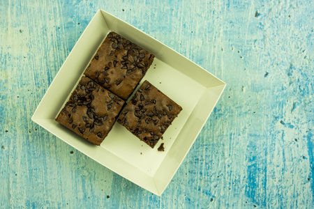 Shot from above stack of chocolate chip brownies in paper boxの写真素材