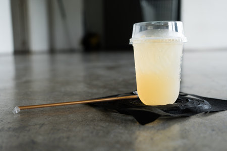 A glass of cold lemon juice mixed with honey. A cool drink is used to quench your thirst during exhausting times.の写真素材