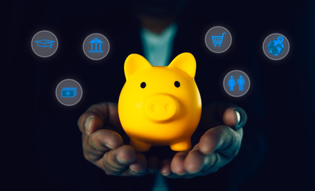 Businessman holding yellow piggy bank with icons of planning family life, insurance, education ,saving money wealth, shopping, travel , investment and emergency fund.の写真素材