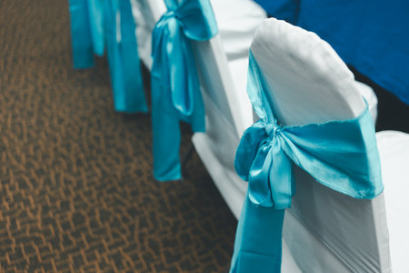 Wedding chair decorate with a blue bow. Wedding chair coversの写真素材