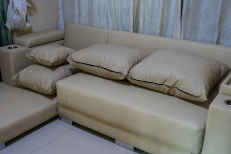 Living room with elegant, big beige couch and seatの写真素材