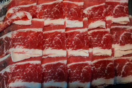 Fresh beef raw sliced with marbled texture served for Sukiyaki and Shabu or Yakinikuの写真素材