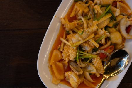 Stir fried squid with salted egg york. Delicious Thai dish. Top viewの写真素材