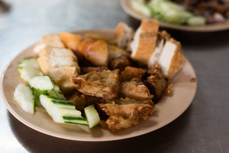 Snack and dessert, Chinese traditional deep fried tofu or fried bean curd served with cucumber slice and eating with sweet and sour spicy sauce.の写真素材
