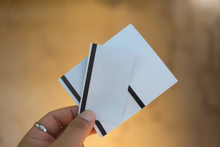 Cropped image of hand showing three paper ticketの写真素材