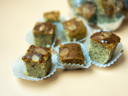 Mini square cut of sweet and soft banana cake served on paper cup. Selective focus. Close up.の写真素材