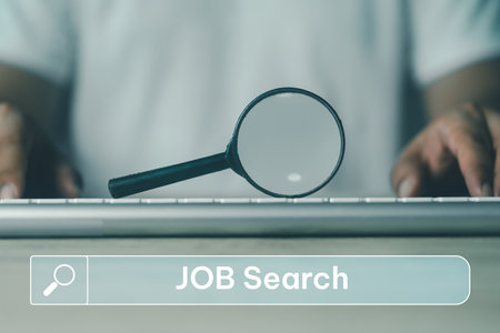 A black magnifying glass was put on the keyboard and search job text on search bar. Job searching online. Surfing the net to find occupation. The concept of resource, choice, and executive.の写真素材