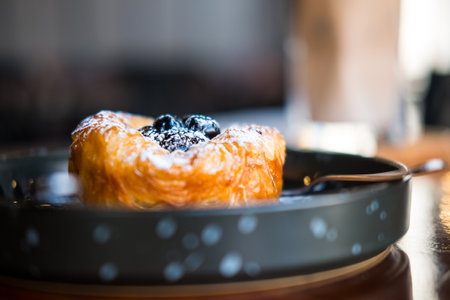 Close up sweet blueberry danish pastry on black dish. Selective focusの写真素材